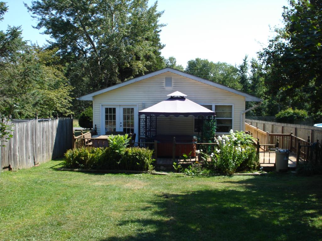 Charming &amp; bright 3 bdrm ranch in a quiet neighborhood.  Features include hardwood floors, dining room, French doors leading to a wrap around deck complete with a hot-tub overlooking a beautiful lot. Basement includes a rec room, a bonus room, a storage room and laundry area.  The attached one car garage and attic provide for additional storage space.