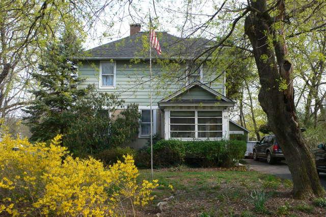 LONGING TO BE RESTORED THIS LARGE 4 BR COLONIAL FEATURES A 10 YR OLD ADDITION WITH 1ST FL MBR W/ FULL BATH  - ESTATE SALE - LBX ON BACK DOOR - FRIENDLY DOG "LEGEND" MAY BE IN HOUSE. 1ST FL BR COULD BE USED AS A FAMILY ROOM AS THERE ARE SLIDERS THAT LEAD OUT TO DECK. LARGE WALKUP ATTIC WAS USED AS A BEDROOM. TERRIFIC LOCATION TO WALK TO TRAIN OR SHOPS IN TOWN  NEW ROOF 2006