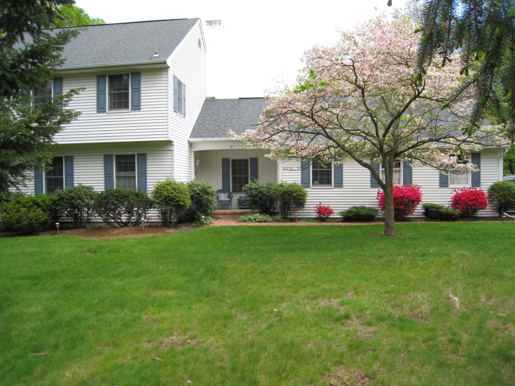 Charming 4 BR col. Inc.beautiful hdwd flrs thruout,lg formal LR &amp; DR, EIK w/SS app,CT flr,opens to year round sunroom w/sliders to deck,FR w/fpl &amp; french doors to deck,3.5bath,septic new in 2003. Hot tub, walk out bsmt, C/A, newer furnace., and  2 car garage.