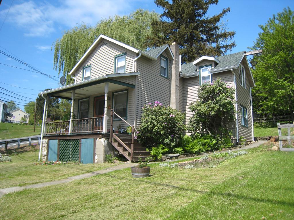 Charming 1800's Colonial with oringal hardwood floors , newer windows,public sewer,3 bedrooms, corner lot with stream 
