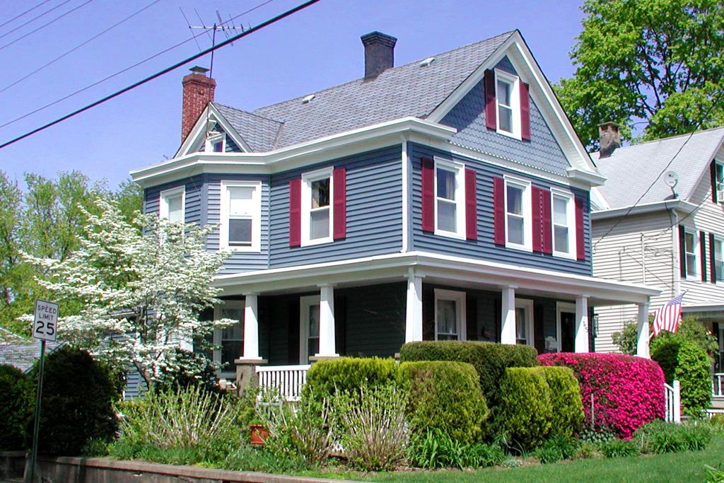 Side-hall colonial w/classic architecture. Wrap-around porch, gardens, stone fireplace, wood floors, formal dining rm, MSBDRM w/walk-in cedar closet, bay windows, walk-up attic, CA, new roof/windows Warmth &amp; Charm abound! Close to park, schools, shopping, houses of worship. Move-in condition.