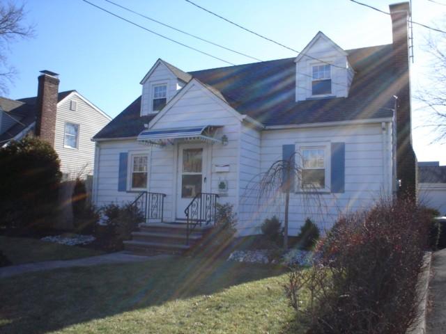 Center hall custom cape with formal DR w/built in corner cabinet &amp; chair rail, Wood burning FP in LR,hardwood floors thruout.  All new windows, new roof (house &amp; garage), updated elec., gas furnace. New front steps and professional landscaping.  Finished Rec Room w/ new carpet and retro bar.  Lots of closets!