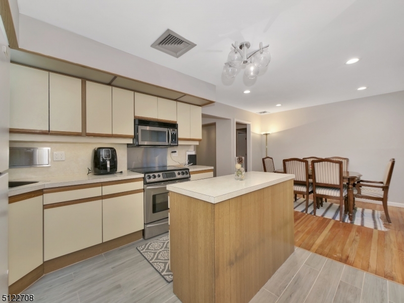 The kitchen offers center island, stainless steel appliances and separate dining area.