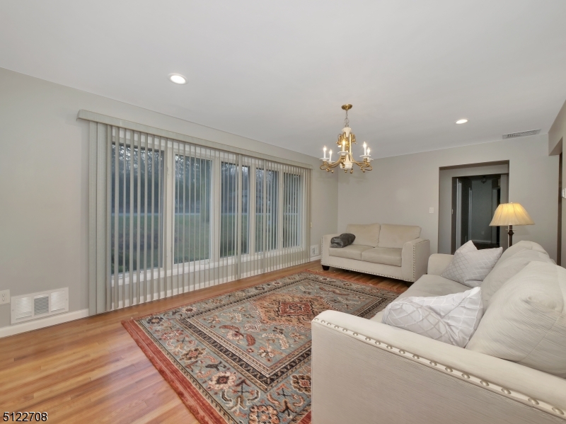 Large windows in the living room give off great natural light and beautifully accent the hardwood floors.
