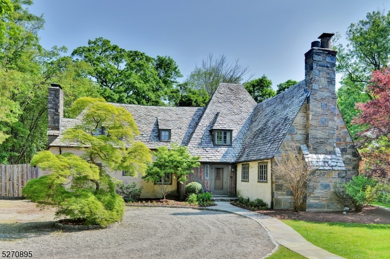 Nestled in the heart of Montclair's Estate Section, this magnificent Cotswold-style Arts and Crafts Tudor home on 2/3 acre stands as a timeless masterpiece of architectural elegance and modern luxury.