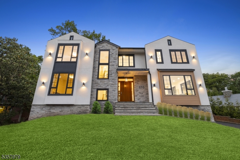 As twilight settles over Short Hills, this custom-built estate glows with warmth, showcasing over 8,000 sq ft of refined living. Set on high ground, it offers exceptional privacy and a prestigious location.