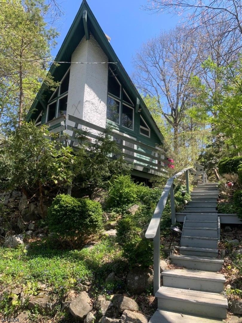 Front of property with stairs leading up