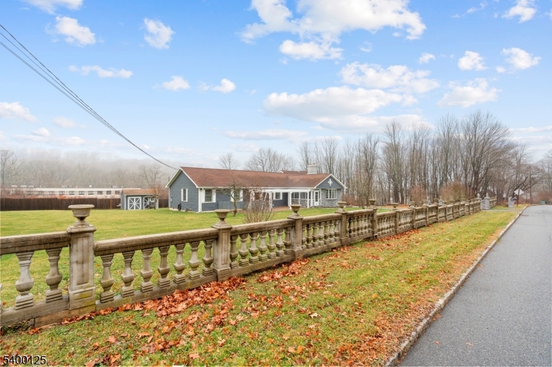 Property features a decorative, custom-built security fence.