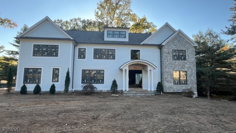 Landscaping in progress. Hardie Shake, Anderson 400 series windows in Taratone. Incredible stone detail, underground sprinklers and sod.