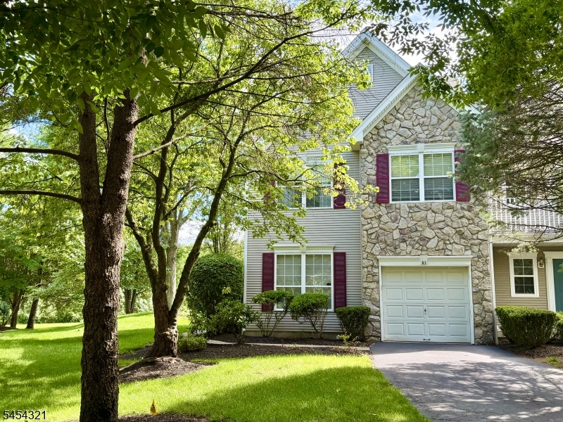 Front of home End-unit townhouse with a 3-car long driveway