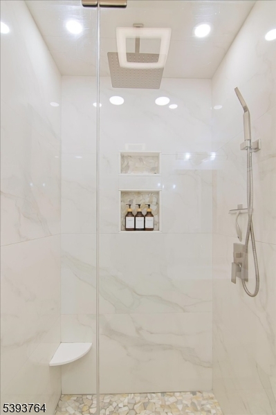 PRIMARY BEDROOM SHOWER What an amazing shower! Built in shelving making simpler living.