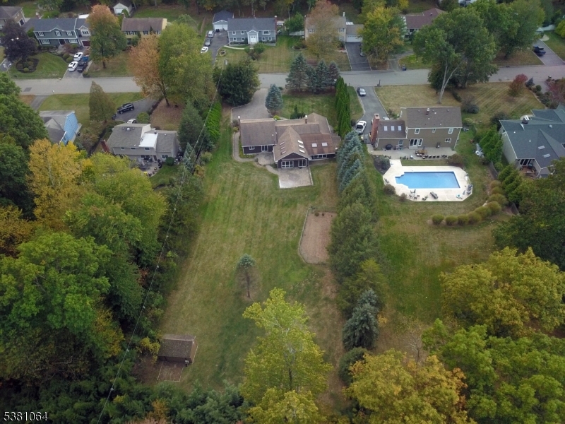 rear aerial view Home has privacy shrubs and has a fenced in yard.