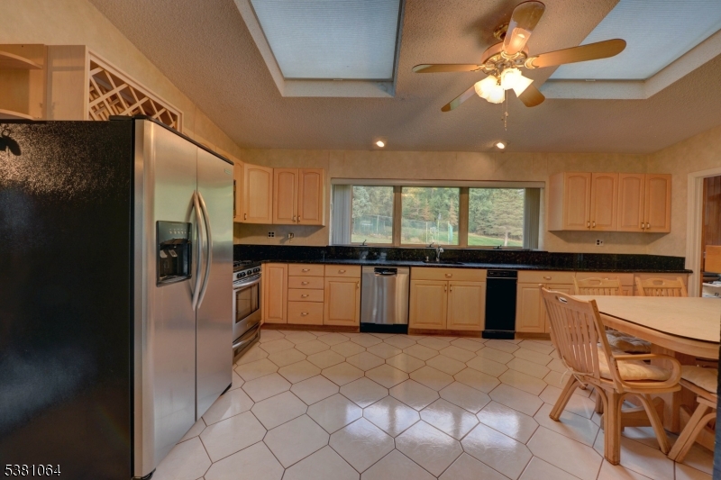 rear kitchen Kitchen is bright w skylights and has an eat-in area.