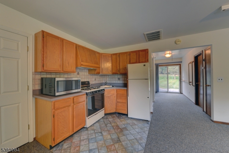 kitchenette Kitchenette has wood cabinets, stove and refrigerator.