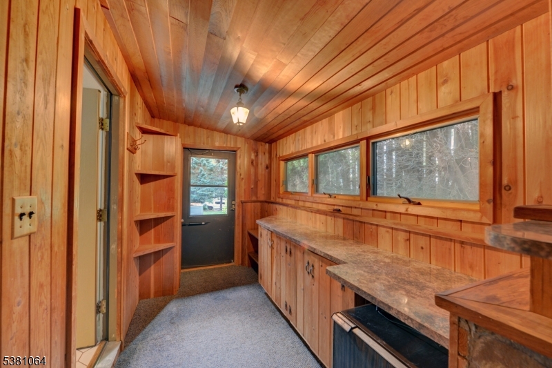 side prep kitchen Prep room off kitchen withample cabinets and exit to side rear of home.