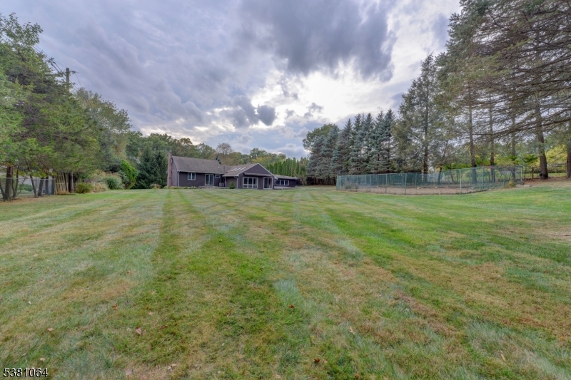 rear of home and yard Rear yard has an enclosed area for a and vegetable garden and a rear shed.