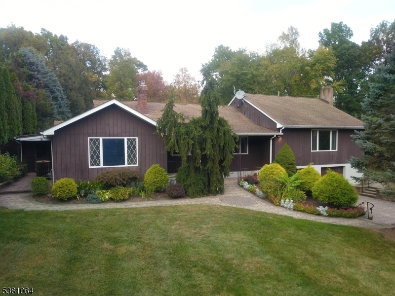 Lots of curb appeal with beautiful landscaping and a paver walkway to the front door.