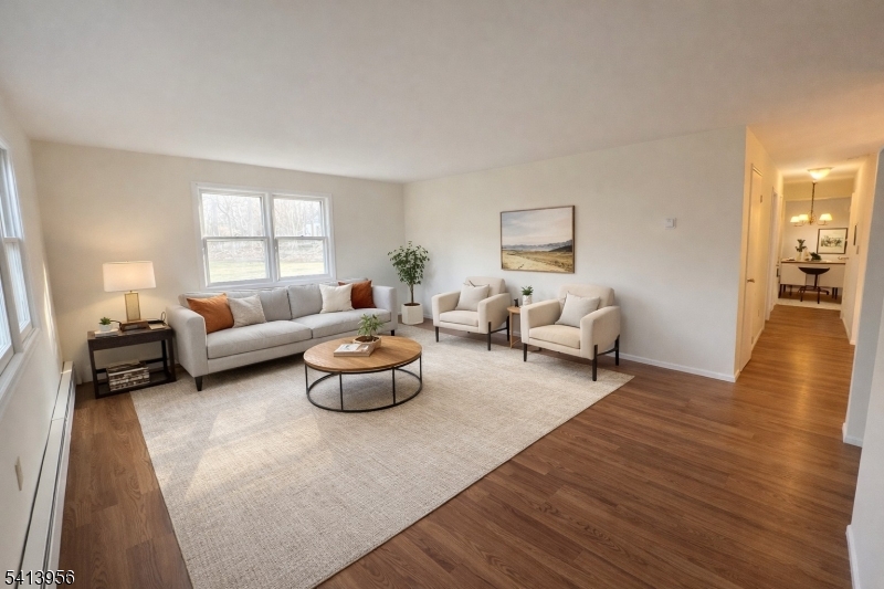 20 x 15 living room Vinyl flooring, freshly painted. View to patio and woods. A convenient foyer with a coat closet. The living room has a view to dining room and kitchen