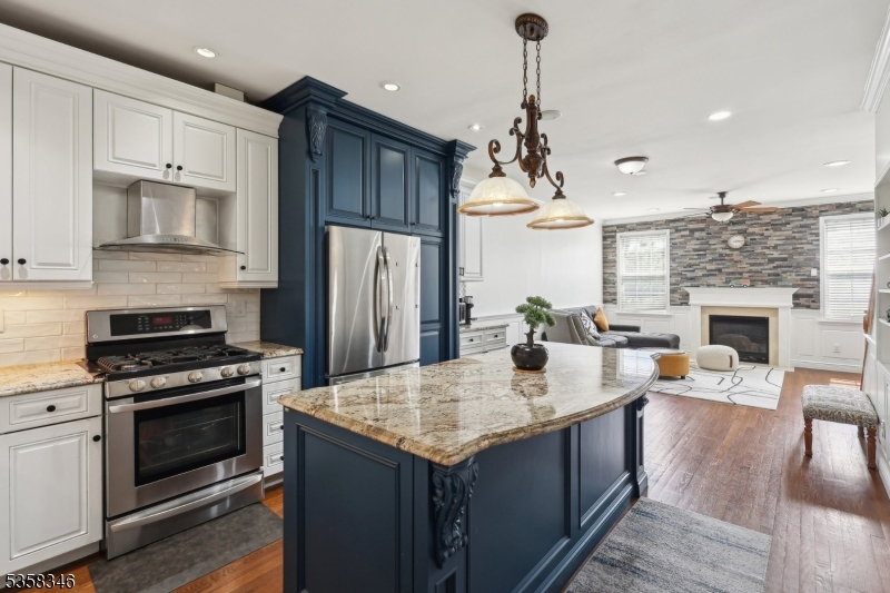 Wonderfully updated kitchen with cabinet lights and stainless steel appliances. Large center island