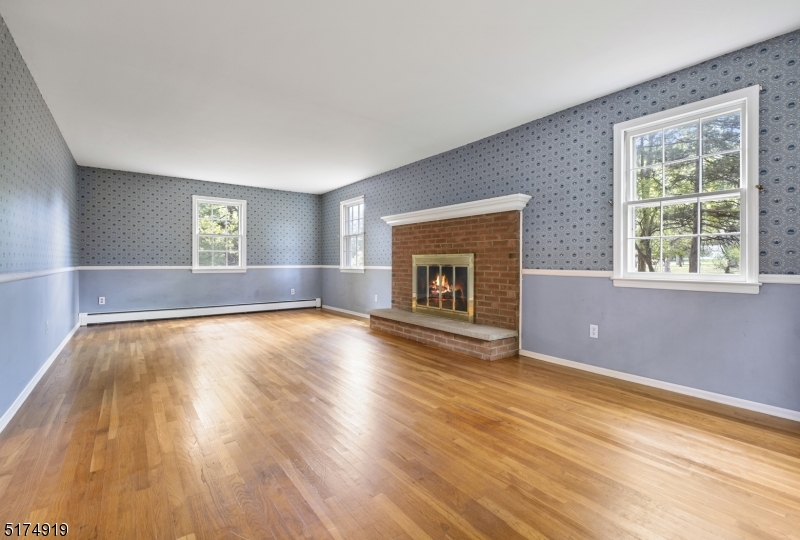 Large sunny room with lots of light and cozy wood burning fireplace. Beautiful hardwood floors throughout.