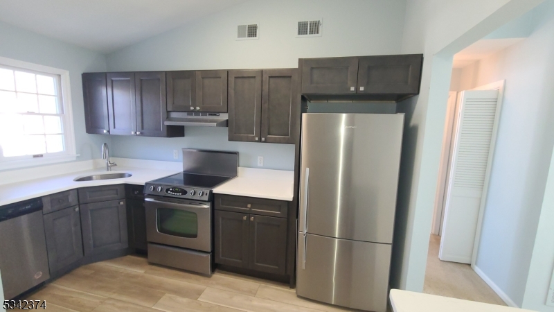 Totally new kitchen with quartz counter tops, fine wood cabinets, stainless steel appliances, and new floor.