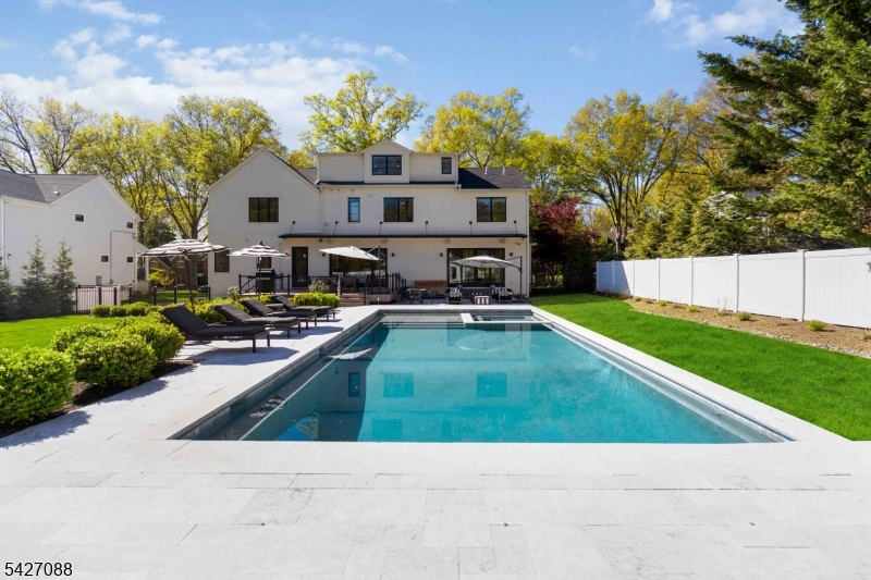 Stunning 20x40 heated gunite pool with multiple lounge areas and large additional yard space