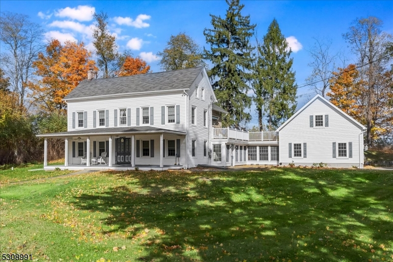 Two car attached garage with high ceilings and possible storage as well as a 2 car detached garage and a storage barn.