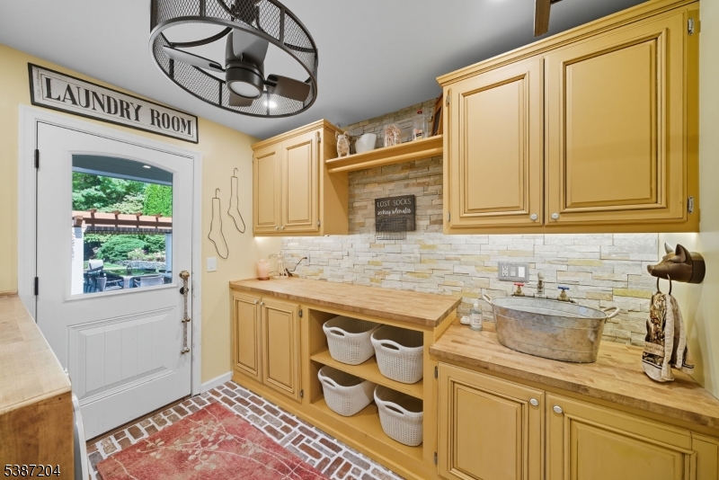 Laundry room. Custom cabinets. Door to rear patio.