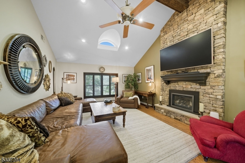 Family Room. Custom stone work with gas fireplace. Overlooking the front and rear gardens.