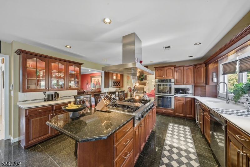 Kitchen Spacious with cherry cabinets.