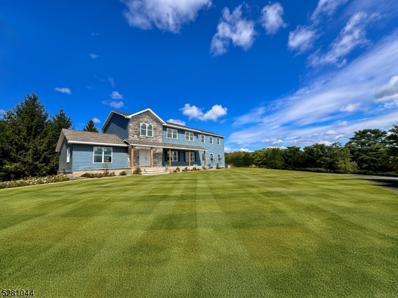 Stone siding is rendered using AI - Exact color may vary. Grass is currently seeded and hayed ( Grass is rendered)