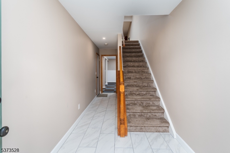 Foyer Stairs to main level / hall to Rec room and garage