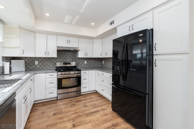 Kitchen  w New Cabinets Stone Counters and custom backsplash
