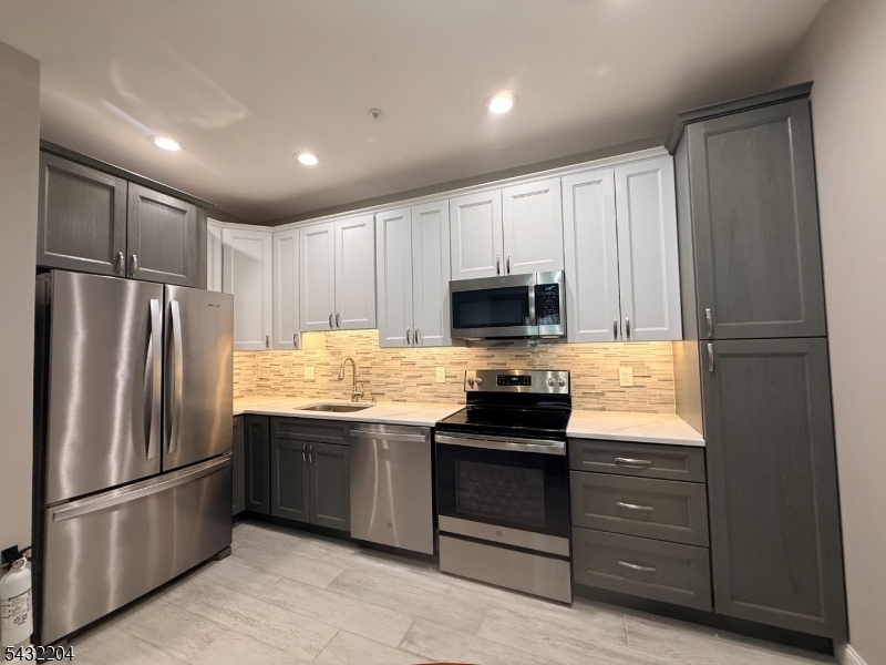 Kitchen Beautiful completely renovated kitchen, featuring GE & Whirl Pool appliances. Cabinets feature brushed nickel handles. Side cabinets open to pantry space