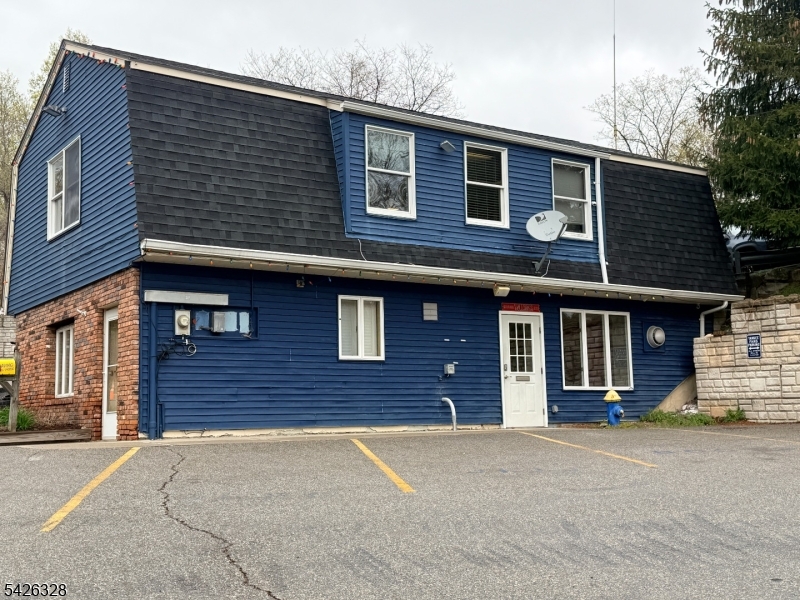 Exterior of building Unit entry is the white door, two front parking spaces available