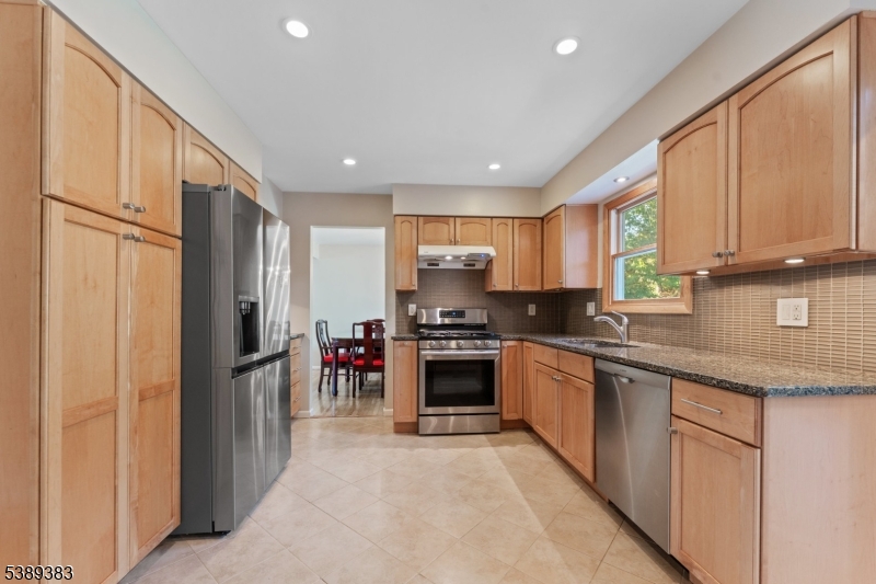 Kitchen Kitchen with stainless steel appliances, granite countertops, tile backsplash and ample cabinet space.