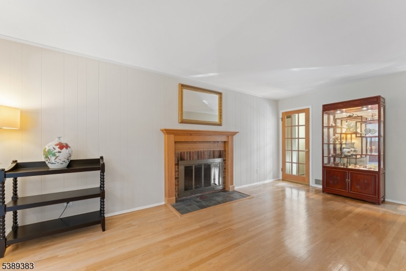 Den The den with hardwood floor and fireplace.