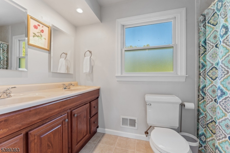 Main Bath Second floor full bath with dual sink vanity, tile floor and tub shower.
