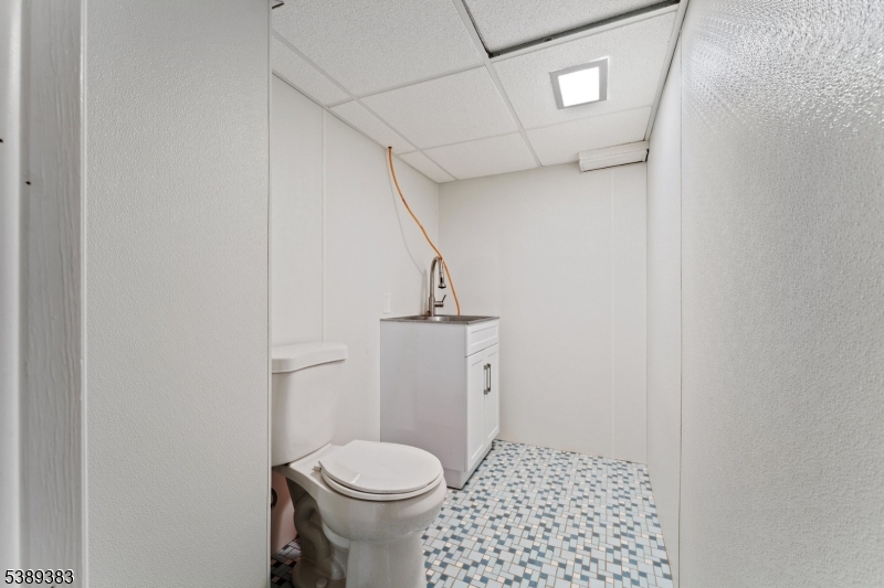 Basement Basement half bath with tile floor.