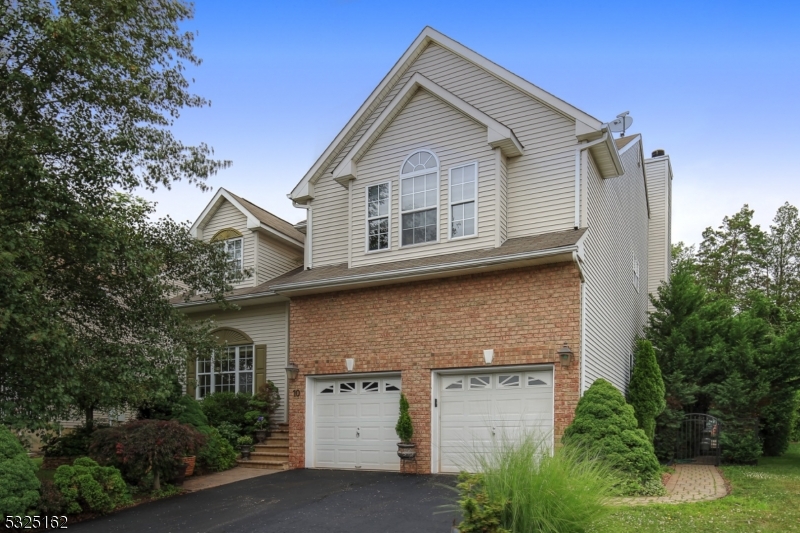 Brick-Accented Colonial presenting four bedrooms and 3.5 baths, on a quiet cul de sac at The Golden Pines enclave of homes.