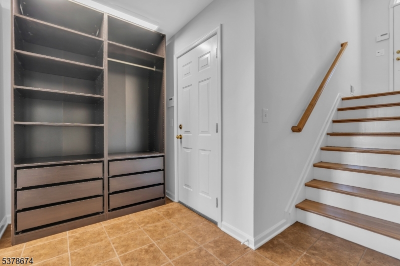 Foyer entry Two car attached garage open to the foyer entry with built-in drop zone and an additional closet large closet under staircase.