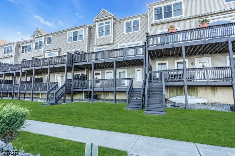 Back of townhome Sidewalks light up in the evening. Storage under deck for kayaks and paddle boards.
