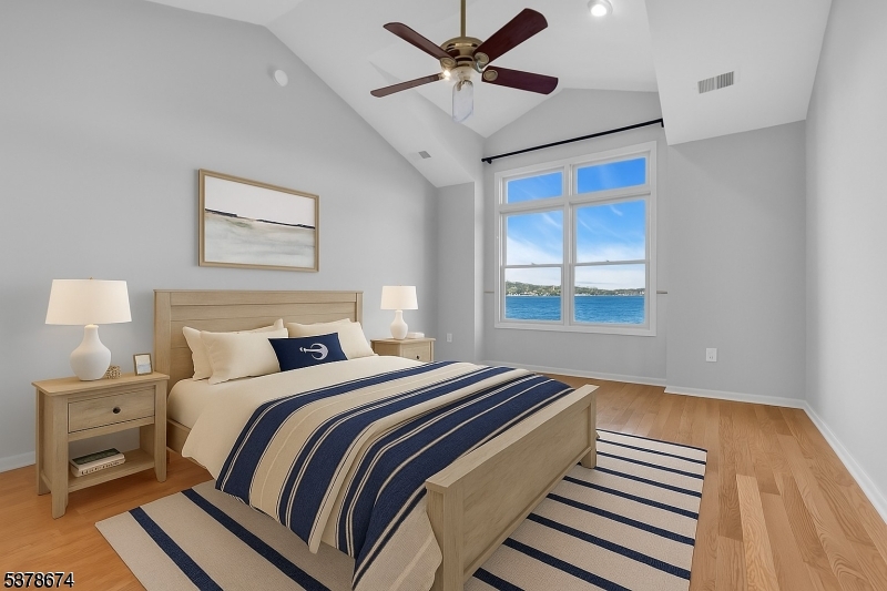Primary bedroom lakefront Vaulted ceiling, fan/light combo. Two walk-in closets with built-in cabinetry. Full bath with jetted tub and separate walk-in shower