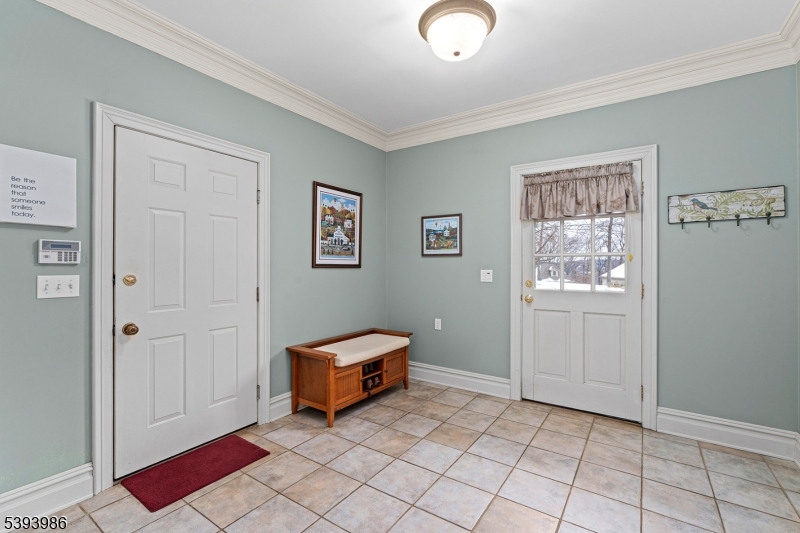 Mud Room Secondary Front Entrance, Garage Access, Powder Room, and Storage Closet