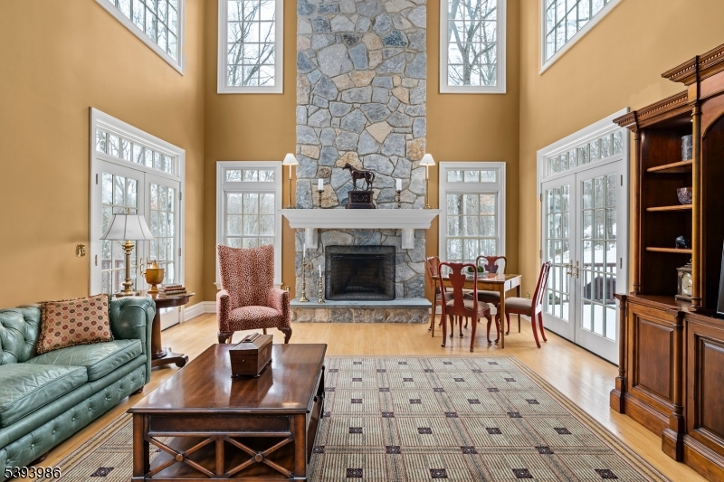 Great Room Two-Story Stone Fireplace and French Doors to Expansive Deck