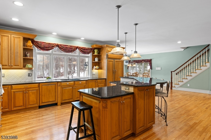 Kitchen Hardwood Floors, Large Center Island w/ Seating, Walk-in Pantry, Custom Cabinetry, and Granite Counters