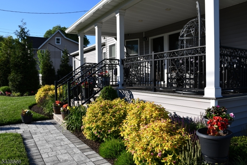 Front View Beautifully renovated home with covered front porch, graciously landscaped and impeccably manicured property