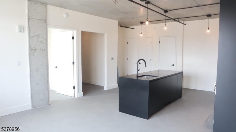 Kitchen/Living Room Double Doors Contains Stacked Up Washer/Dryer, the flex room, one bedroom