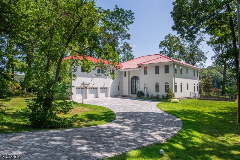 Enjoy all that Mountain Lakes has to offer plus every modern amenity from this exquisite custom home! Wind down the paver driveway to this magnificent, custom home!