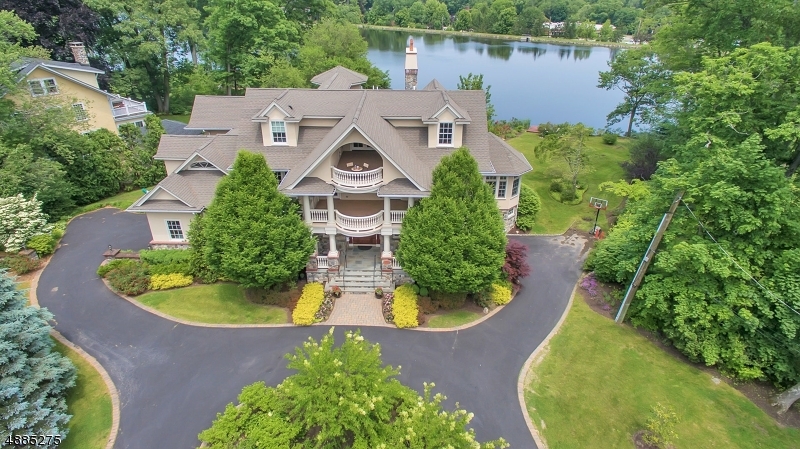 Magnificent, palatial home overlooks glistening Wildwood Lake on an expansive property bordering lovely park. Ideal location close to schools, & NYC bus.